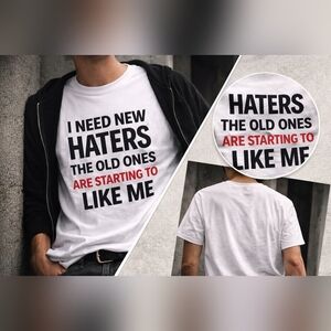 I Need New Haters – Funny, Bold Statement Tee | White Graphic Shirt (Unisex)